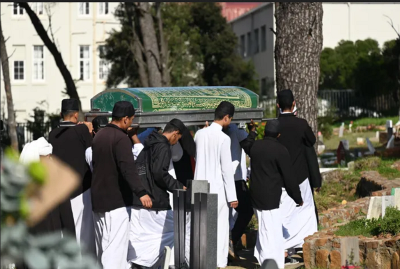 Men carrying a janazah through a cemetery